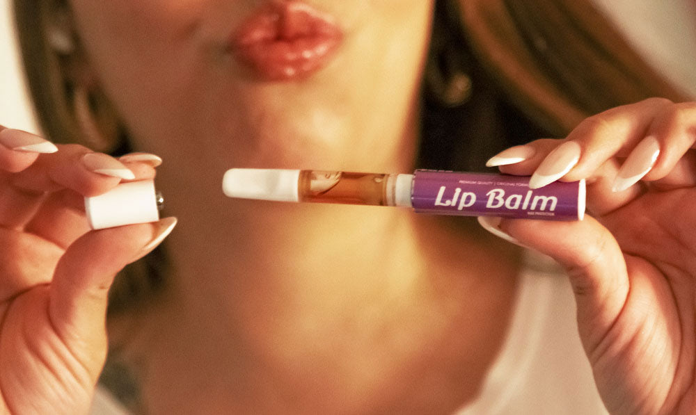 woman holding Smyle Chapstick apart