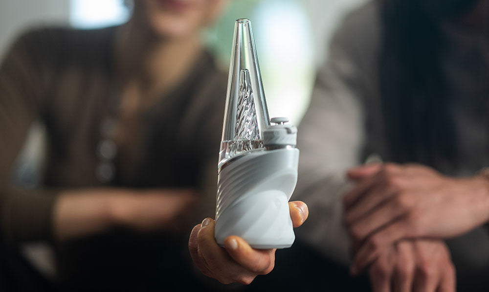 Person holding a Puffco Peak Pro electronic rig