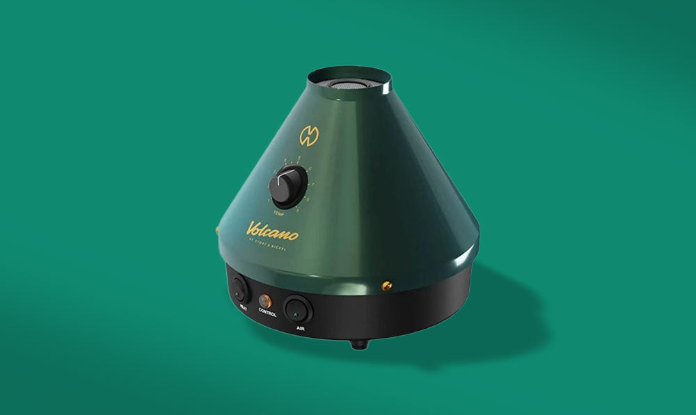 Green Storz and Bickel Volcano vaporizer against a teal background