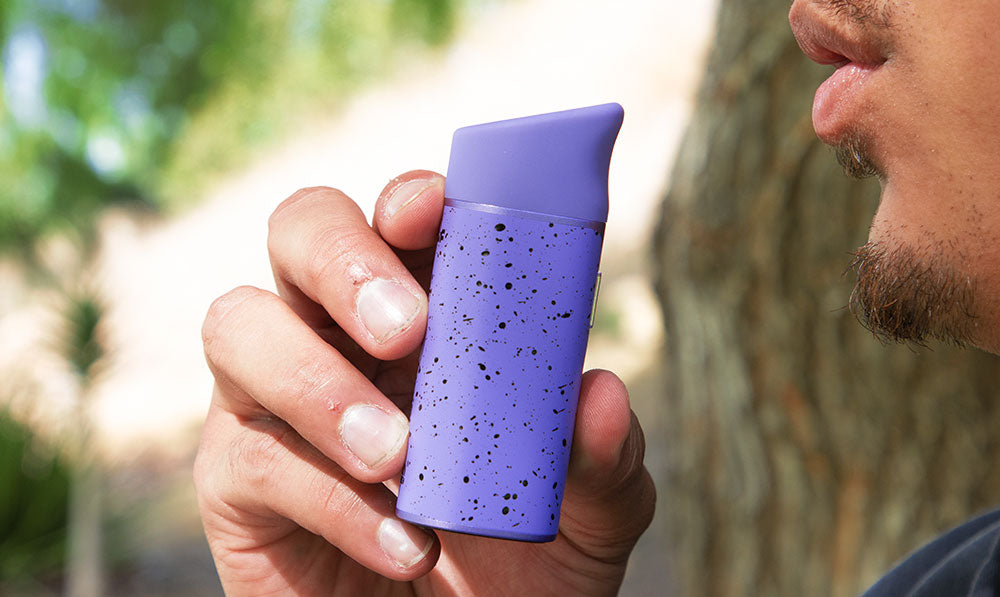Wulf Pocket Mini purple-black spatter being demoed in lifestyle shot