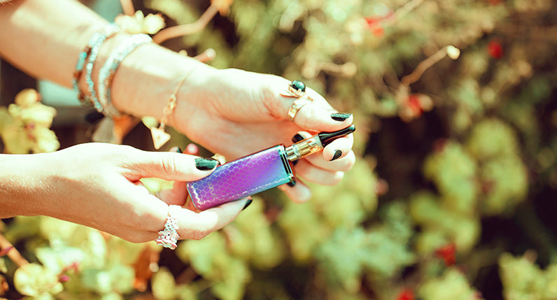 Woman holding Full Color Cobra Exxus MiNovo outside at park near bushes
