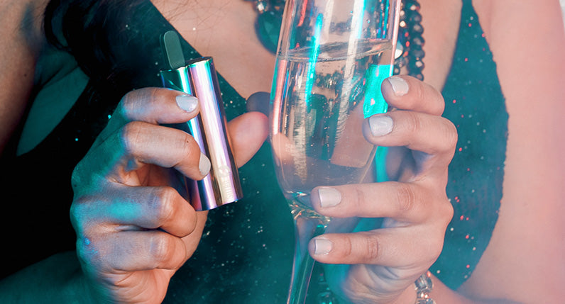 woman with champagne holding the Sutra Auto