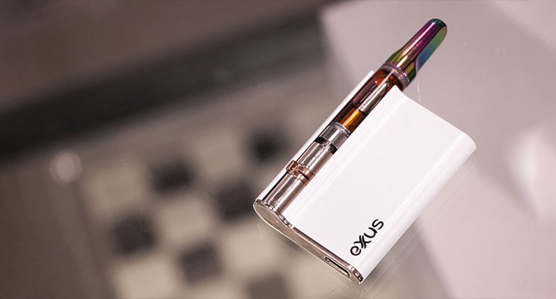 Exxus Palm Pro laying down on glass table inside office