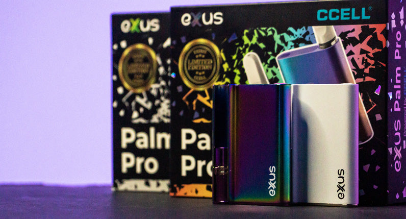 Exxus Palm Pro standing on black desk with packaging and with blue background