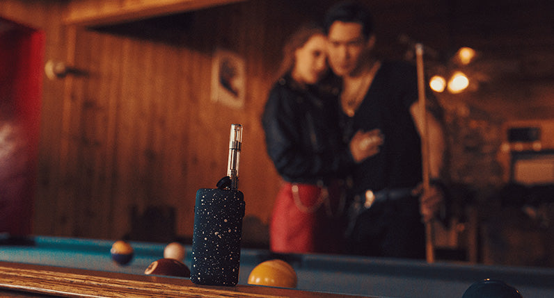 Exxus Push standing on pool table with couple in background
