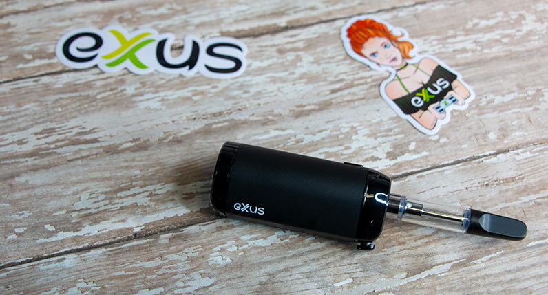 Exxus VRS cartridge mode laying down on wooden table next to Exxus stickers