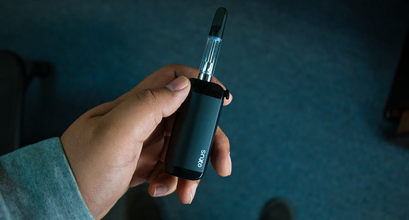Man holding Exxus VRS cartridge mode inside office