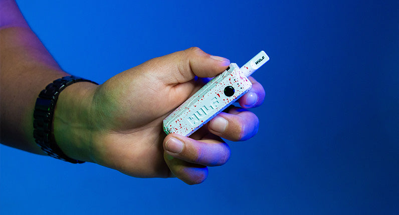 man holding the UNI Max with blue background