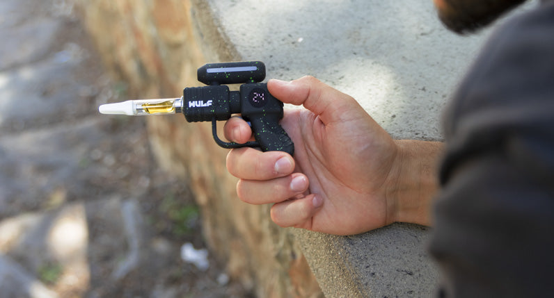 Person leaning over a wall holding a WULF Zapp 510 thread battery