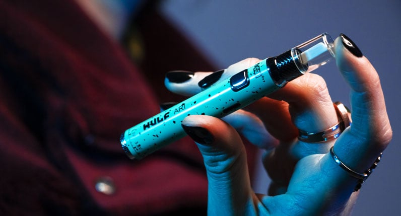 Person holding Wulf ARI Hot Knife under soft blue lighting