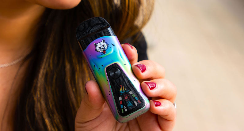 Person holding a WULF Flex dual use vaporizer with its screen lit