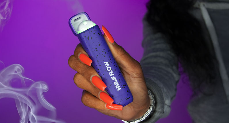 Woman holding Wulf Flow in front of purple studio background
