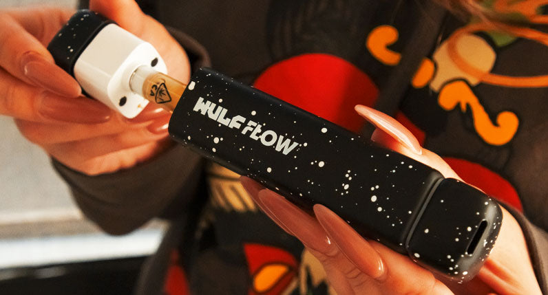 Woman in hoodie inserting cartridge into Wulf Flow