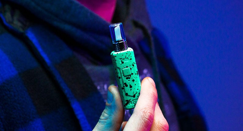 Wulf KODO Knife in person's hands in front of blue studio background