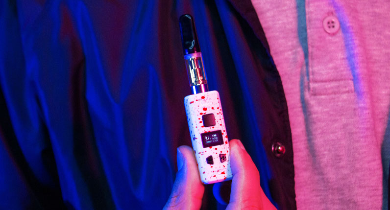 Person holding Wulf KODO Pro under soft blue and pink studio lighting