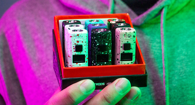 Person holding Wulf KODO Pro pack in hand under pink and green studio lighting