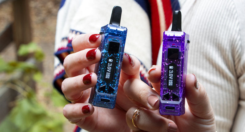 Two women holding Wulf X-Ray UNI Pro in front of park bridge