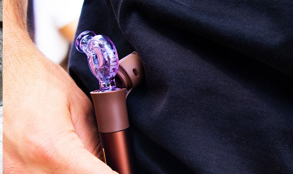 man with wulf attachment in his puffco pivot in his pocket lifestyle image